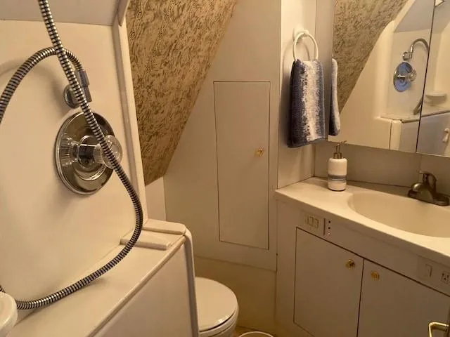 Slide: The Image of 1998 Ocean Yachts 45 Super Sport bathroom with shower, sink, and toilet. - 17