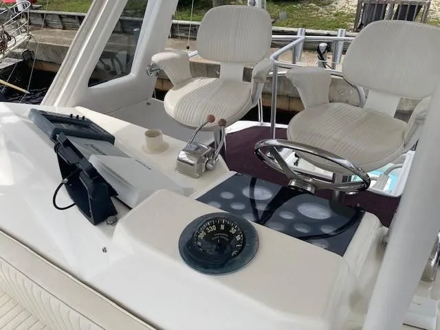 Slide: The Image of 1998 Ocean Yachts 45 Super Sport helm with dual captain chairs and navigation instruments. - 3