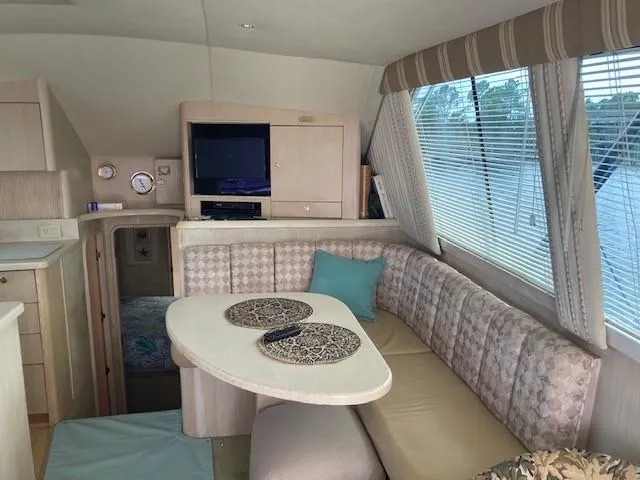 Slide: The Image of Interior of 1998 Ocean Yachts 45 Super Sport with dining area and TV. - 6