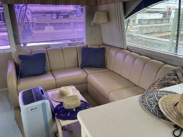 Slide: The Image of Interior of 1998 Ocean Yachts 45 Super Sport with beige leather seating and blue cushions. - 7