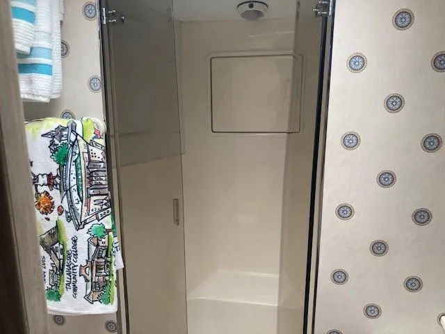 Slide: The Image of Shower area in 1998 Ocean Yachts 45 Super Sport with patterned wallpaper and colorful towel. - 16