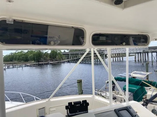 Slide: The Image of 1998 Ocean Yachts 45 Super Sport cockpit view with bridge and waterway in background. - 4