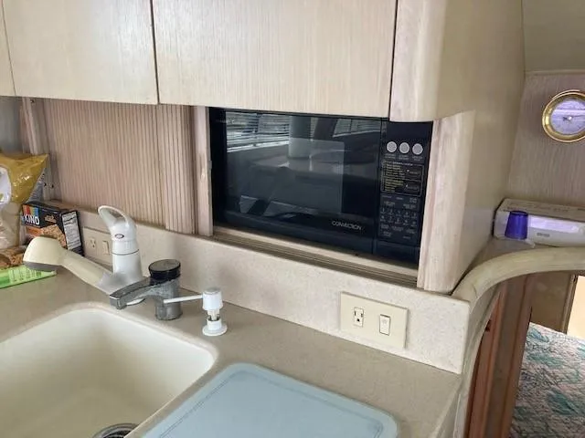Slide: The Image of 1998 Ocean Yachts 45 Super Sport kitchen with sink, microwave, and countertop. - 8