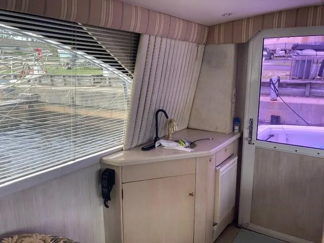 Slide: The Image of Interior of 1998 Ocean Yachts 45 Super Sport with kitchenette and window view. - 9