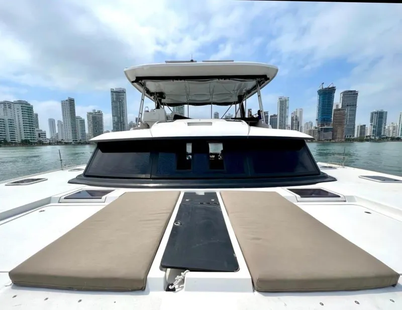 Slide: The Image of 2017 Fountaine Pajot Ipanema 58 Power Catamaran with city skyline in the background. - 15