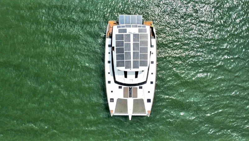 Slide: The Image of Aerial view of 2017 Fountaine Pajot Ipanema 58 Power Catamaran on green water. - 2