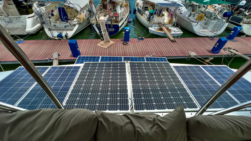 Slide: The Image of 2017 Fountaine Pajot Ipanema 58 Power Catamaran with solar panels docked at marina. - 23