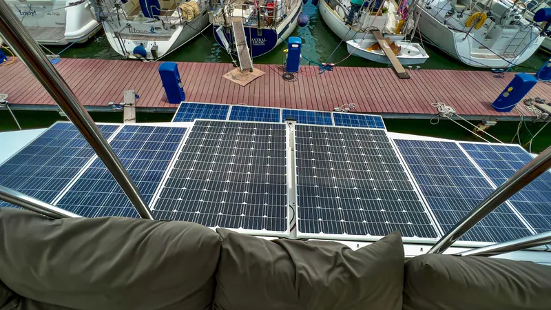 Slide: The Image of Solar panels on a 2017 Fountaine Pajot Ipanema 58 Power Catamaran docked at a marina. - 24