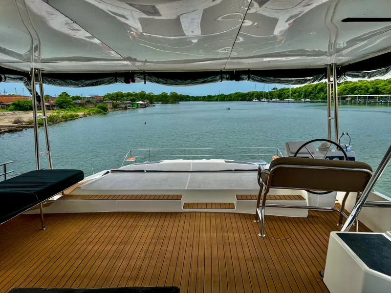 Slide: The Image of 2017 Fountaine Pajot Ipanema 58 Power Catamaran, rear deck view over serene waters. - 26