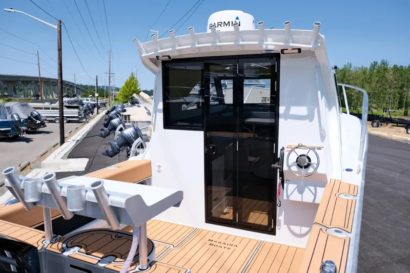 Slide: The Image of 2023 Makaira Gen3 800 boat with teak deck and modern cabin design. - 10