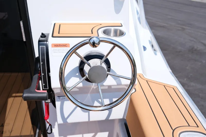 Slide: The Image of Steering wheel of 2023 Makaira Gen3 800 boat with modern design and controls. - 13
