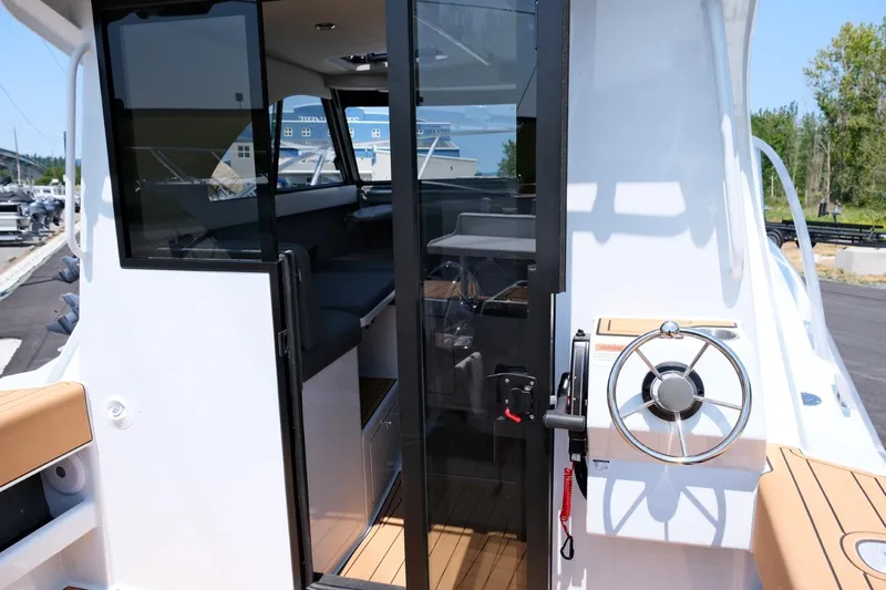 Slide: The Image of 2023 Makaira Gen3 800 boat interior with steering wheel and seating area. - 15