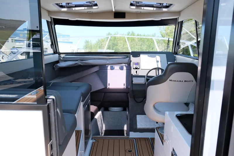 Slide: The Image of Interior of 2023 Makaira Gen3 800 boat, featuring modern seating and navigation area. - 16