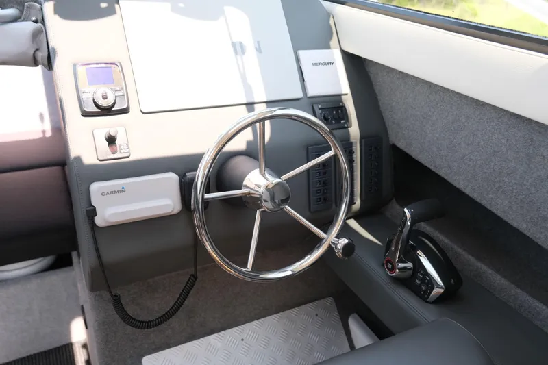 Slide: The Image of 2023 Makaira Gen3 800 boat helm with steering wheel and control panel. - 21