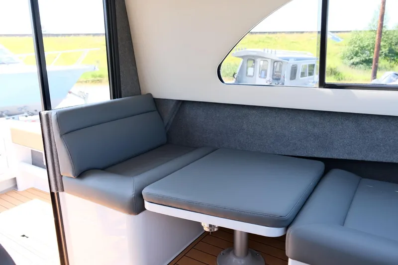 Slide: The Image of 2023 Makaira Gen3 800 interior with gray seating and table, featuring modern design. - 26