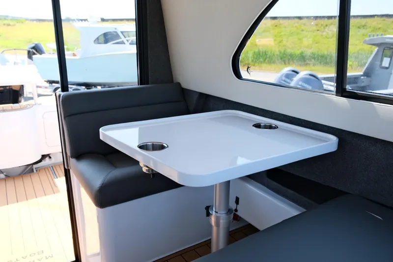 Slide: The Image of Interior of 2023 Makaira Gen3 800 boat with seating and table. - 27
