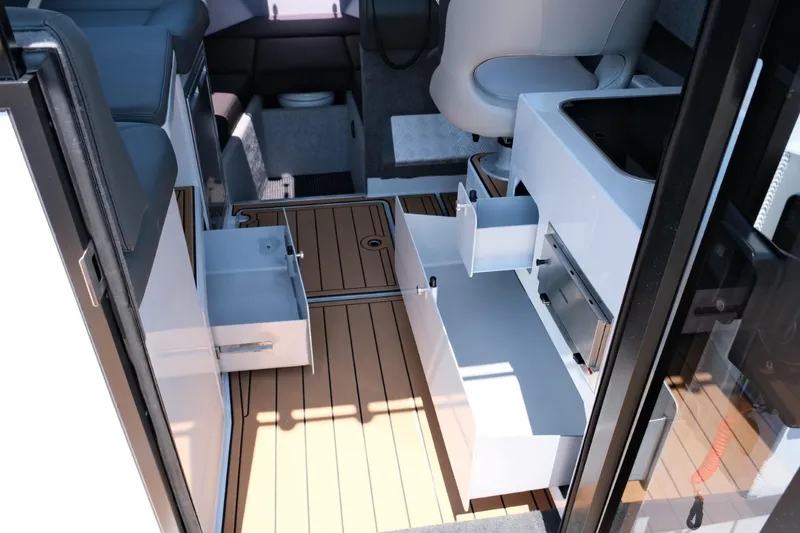 Slide: The Image of 2023 Makaira Gen3 800 interior with open storage drawers and wood flooring. - 29
