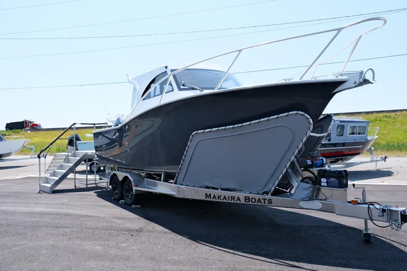Slide: The Image of 2023 Makaira Gen3 800 boat on trailer, displayed outdoors. - 3