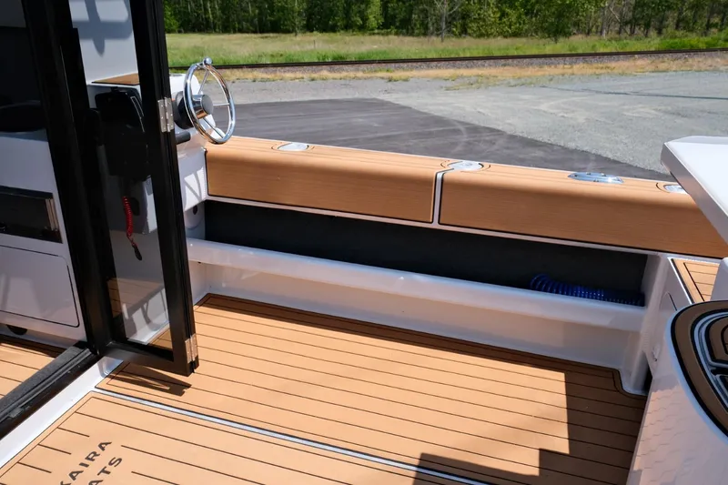 Slide: The Image of Makaira Gen3 800 boat deck, 2023 model, featuring sleek wood finish and modern design. - 31