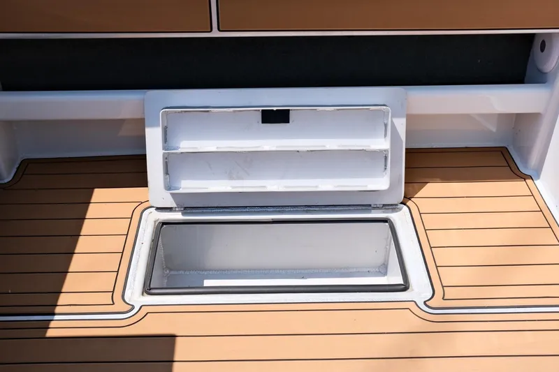 Slide: The Image of 2023 Makaira Gen3 800 boat deck with open storage compartment. - 33