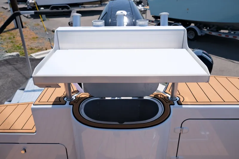 Slide: The Image of Makaira Gen3 800 boat, 2023 model, featuring a sleek deck and storage area. - 34