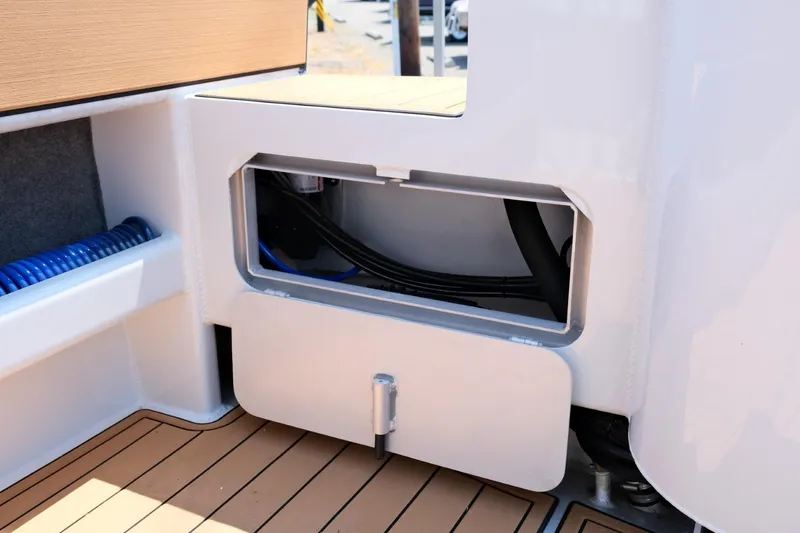 Slide: The Image of 2023 Makaira Gen3 800 boat interior with storage compartment and teak flooring. - 38