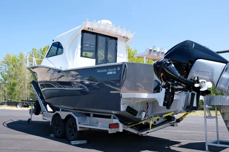 Slide: The Image of 2023 Makaira Gen3 800 boat on trailer, featuring sleek design and powerful outboard motor. - 6