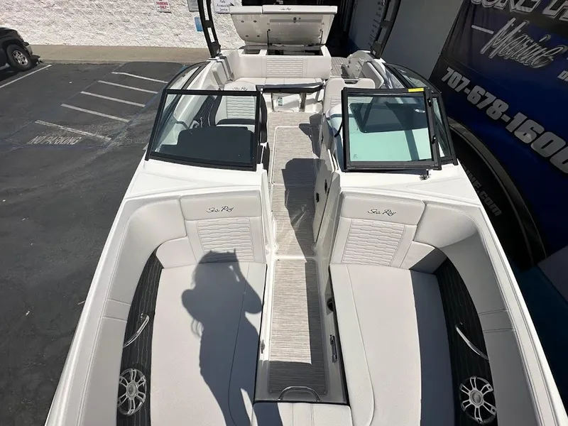 Slide: The Image of 2024 Sea Ray SPX 230 boat interior with white seating and open deck layout. - 14
