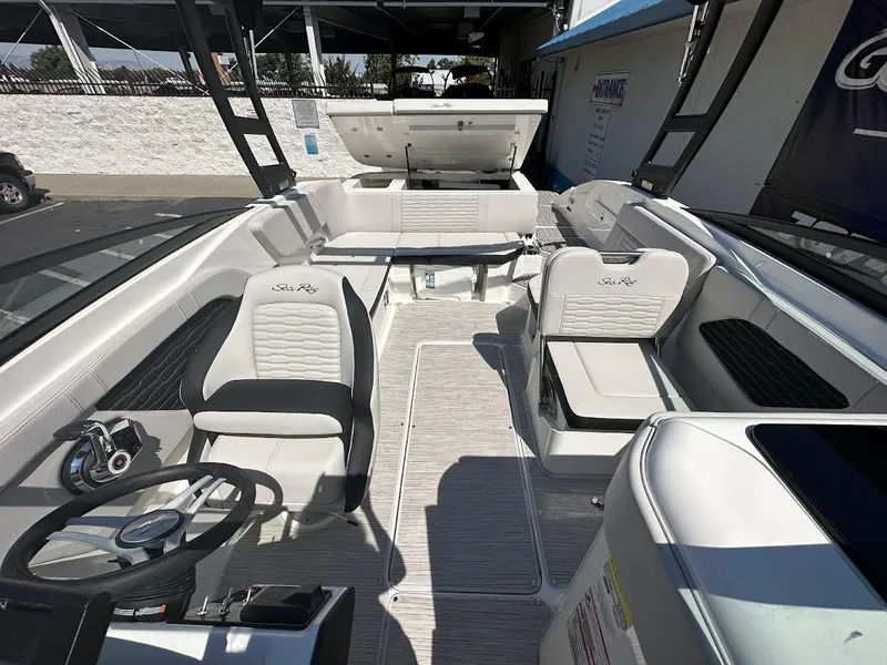 Slide: The Image of 2024 Sea Ray SPX 230 boat interior with seating and steering wheel. - 16