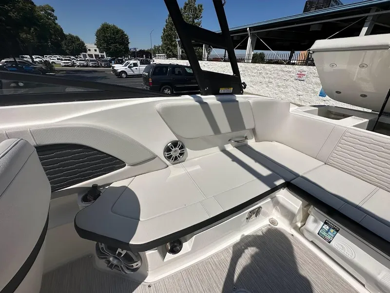 Slide: The Image of 2024 Sea Ray SPX 230 boat interior with white seating and modern design. - 19