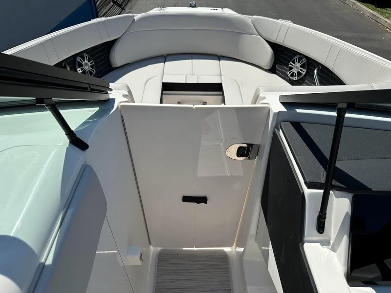 Slide: The Image of 2024 Sea Ray SPX 230 boat interior with white seating and modern design. - 27