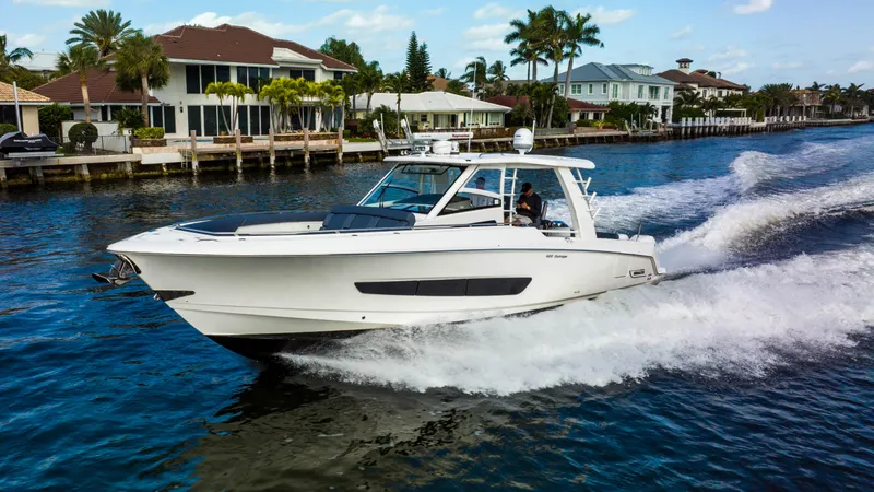 Slide: The Image of 2016 Boston Whaler 420 Outrage cruising on a scenic waterfront. - 1