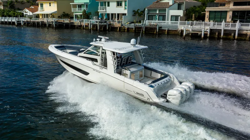 Slide: The Image of 2016 Boston Whaler 420 Outrage cruising on water near waterfront homes. - 10