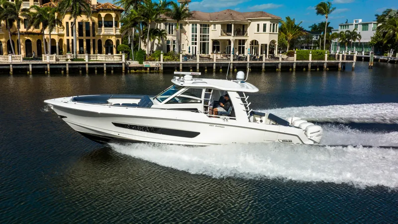 Slide: The Image of 2016 Boston Whaler 420 Outrage cruising on a scenic waterfront. - 11