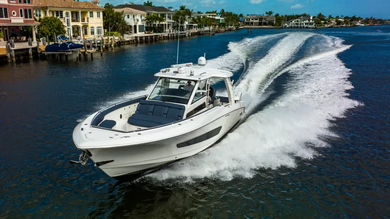 Slide: The Image of 2016 Boston Whaler 420 Outrage cruising on a scenic waterway. - 12