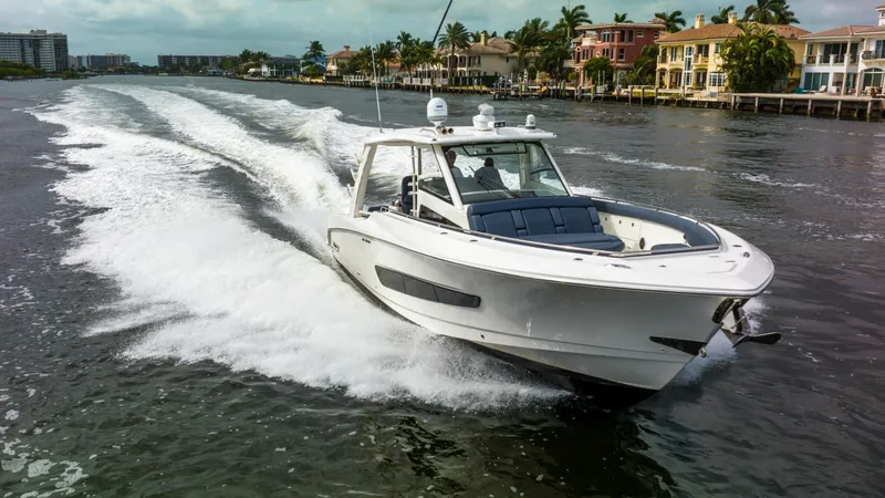 Slide: The Image of Boston Whaler 420 Outrage 2016 cruising on a scenic waterway near luxury homes. - 13