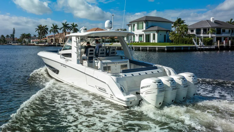 Slide: The Image of 2016 Boston Whaler 420 Outrage cruising on a scenic waterfront. - 2