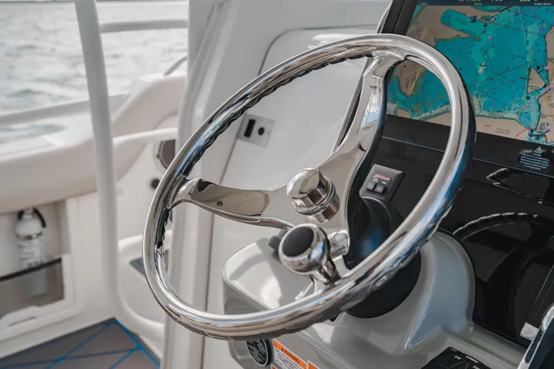 Slide: The Image of Steering wheel of 2016 Boston Whaler 420 Outrage with navigation display. - 25
