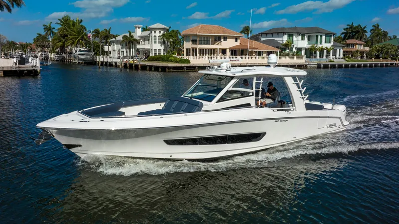 Slide: The Image of 2016 Boston Whaler 420 Outrage cruising on a scenic waterfront. - 3