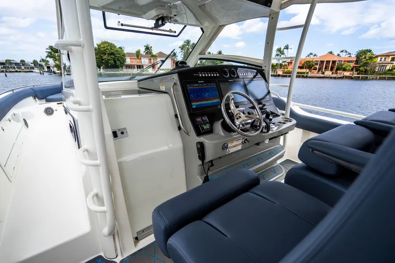 Slide: The Image of 2016 Boston Whaler 420 Outrage helm with modern navigation system and luxurious seating. - 38