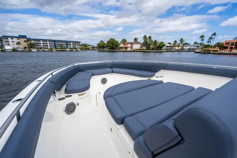 Slide: The Image of 2016 Boston Whaler 420 Outrage boat with spacious seating, docked near waterfront homes. - 39