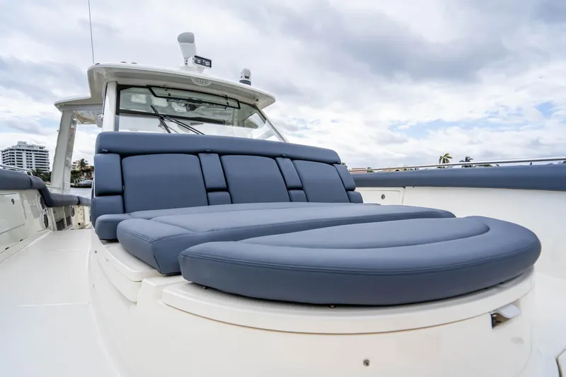 Slide: The Image of 2016 Boston Whaler 420 Outrage boat with luxurious blue seating under cloudy sky. - 41
