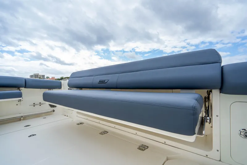 Slide: The Image of 2016 Boston Whaler 420 Outrage boat seating under cloudy sky. - 43