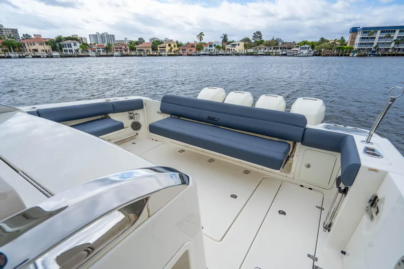 Slide: The Image of 2016 Boston Whaler 420 Outrage boat with spacious seating on a calm waterfront. - 47