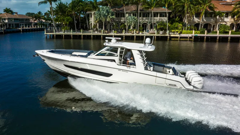 Slide: The Image of 2016 Boston Whaler 420 Outrage cruising on a scenic waterway. - 5