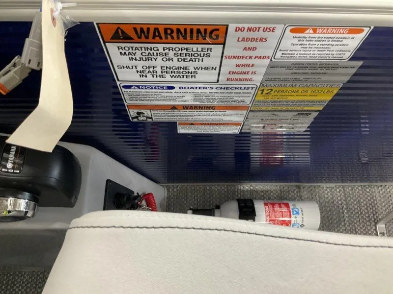 Slide: The Image of Warning labels and safety instructions on a 2023 Bennington 23 LSB boat. - 11