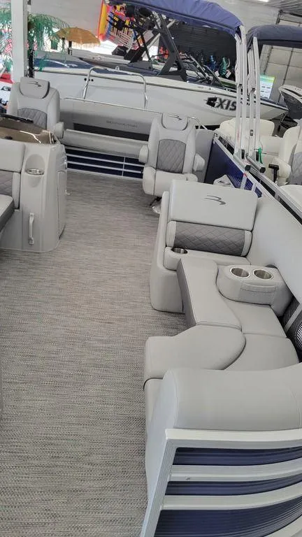 Slide: The Image of 2023 Bennington 23 LSB pontoon boat interior with luxurious seating and modern design. - 17