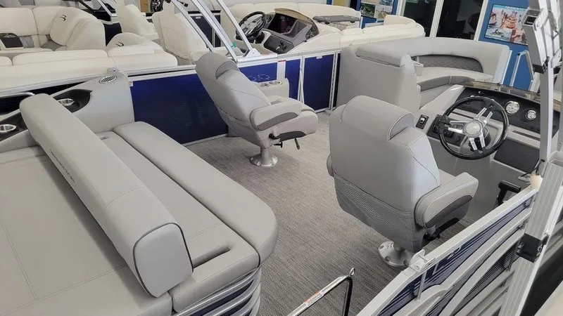Slide: The Image of 2023 Bennington 23 LSB pontoon boat interior with gray seating and modern helm. - 21