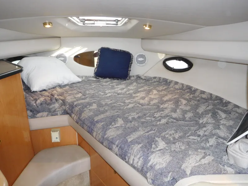 Slide: The Image of Interior cabin of 2000 Regal 2960 Express Cruiser with cozy bed and pillows. - 22