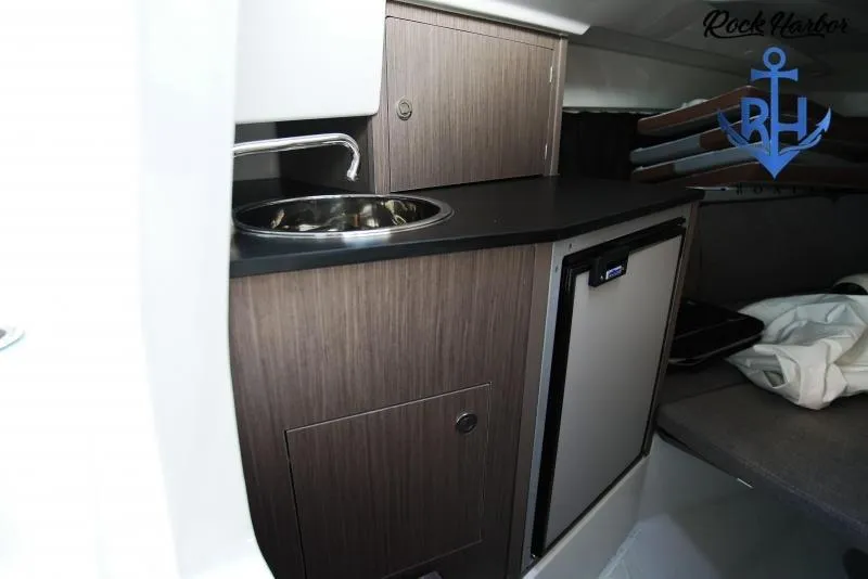 Slide: The Image of 2022 Beneteau Flyer 8 SUNdeck interior kitchenette with sink and mini fridge. - 13